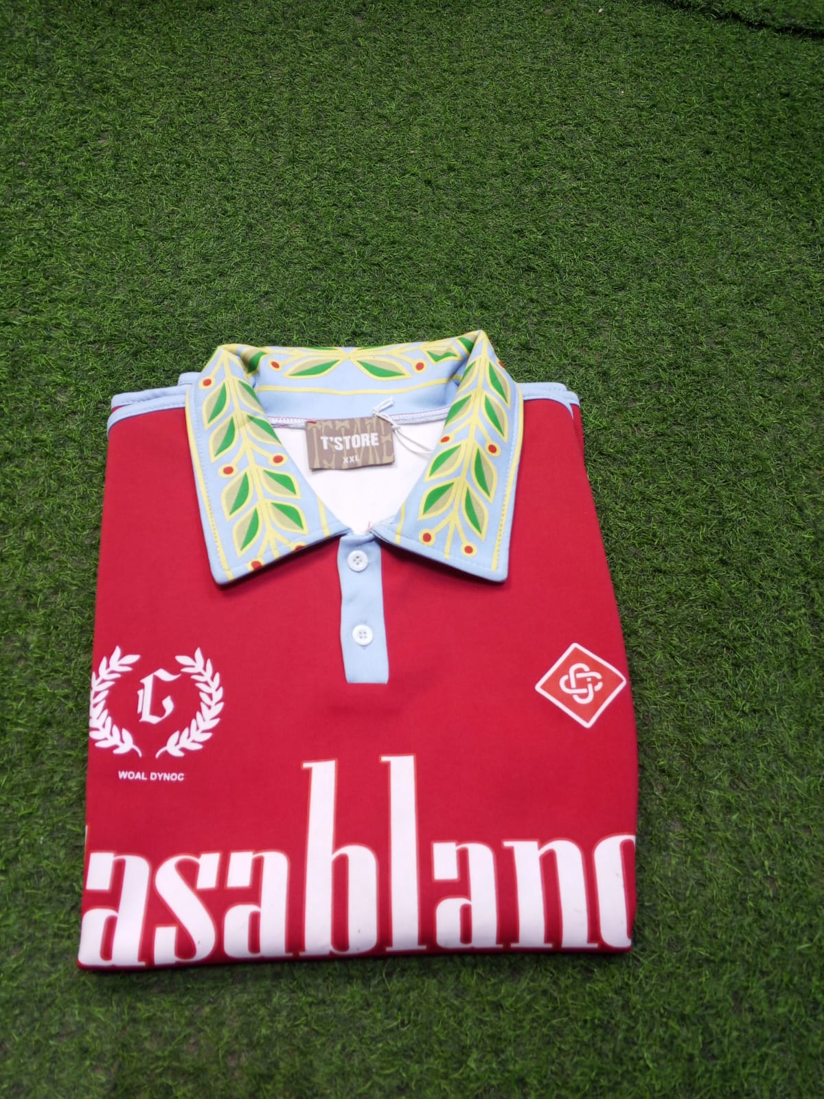 It uses a breathable, textured piqué knit fabric common in luxury polo shirts.