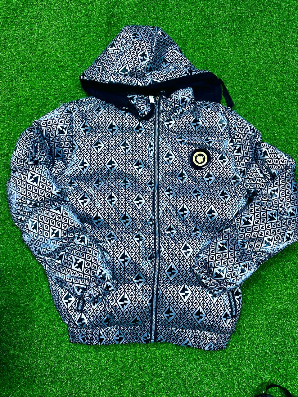  A circular branding badge is positioned on the left chest panel.