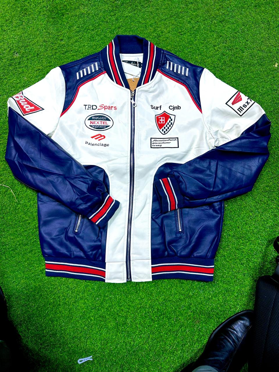 The jacket is heavily decorated with vibrant racing-style embroidered patches